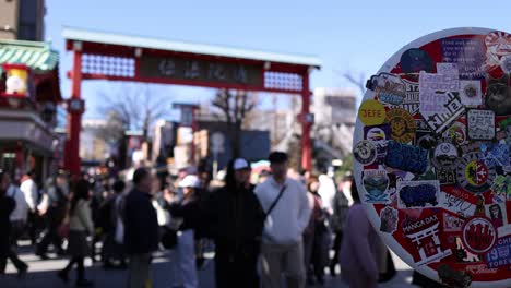 crowds passing through a traditional market gate