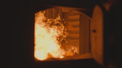 burning charcoal in industrial furnace chamber at plant