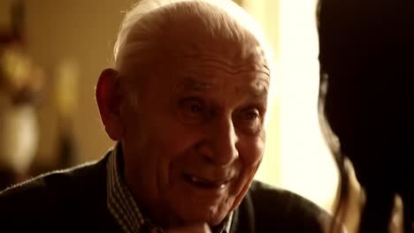 a heartwarming moment of connection: an elderly man shares a joyful conversation with a loved one in a warmly lit room, capturing the essence of cherished memories and bonds
