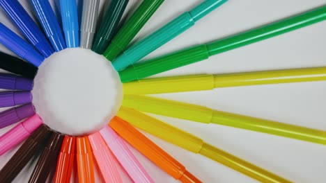 the felt pen on the turntable. the marker spin rotate. twist, create pattern, make design shape circle. top view, flat lay