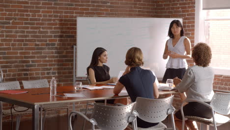 group of businesswomen meeting in modern boardroom