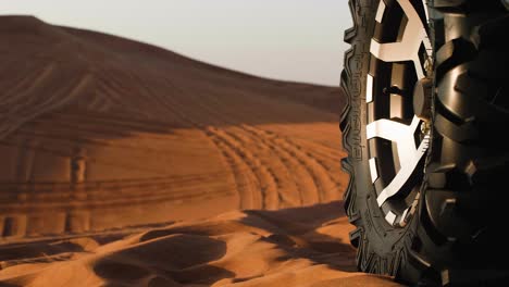 tyre of a buggy in desert sand at a dune ride