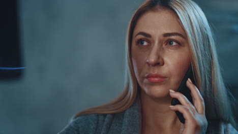 sad woman with phone looks at x-ray picture of ill relative