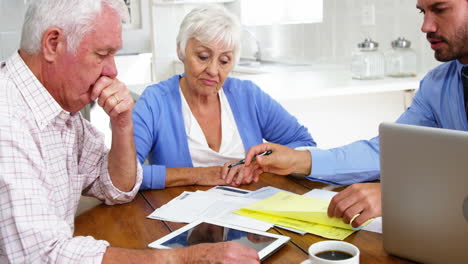 pareja madura llenando algunos documentos formales con el hombre