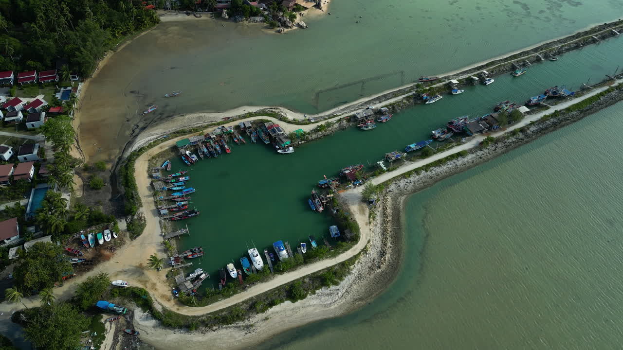 Boats moored at Wok Tum Canal pier, drone view from above