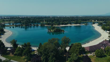 turquoise lake surrounds tree island and beaches in zagreb’s jarun neighborhood