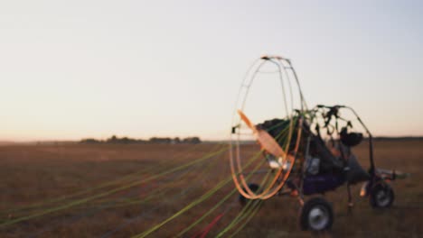 male pilot of a motor glider secures the parachute to the body of the glider in preparation for the flight and checking the equipment. spread the parachute