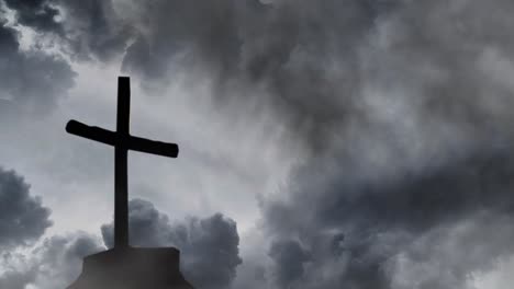 silhouette of a wooden cross against a stormy background