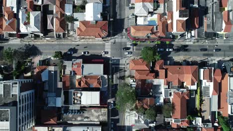 backward movement with drone filming on camera 90 degrees down, empty streets in big city full of buildings and houses, mobility, traffic, corona virus, in 4k resolution