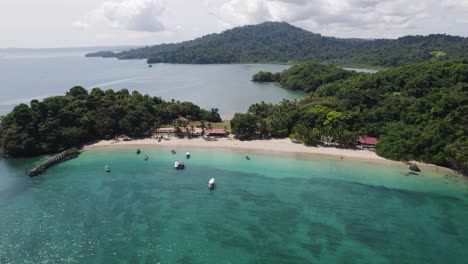 the tropical coiba island in panama with clear waters, sandy beach, and lush greenery, aerial view