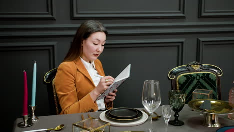 asian woman sitting at elegant table