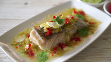 steamed grouper fish fillet with chili lime sauce in lime dressing