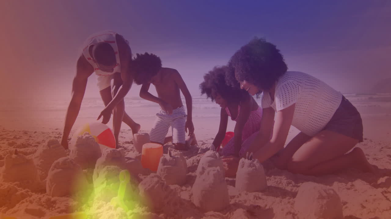 Building sandcastles, family enjoying animation of colorful lights on beach