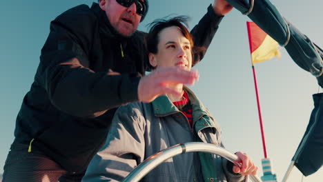 Man,-boy-and-steering-wheel-in-boat