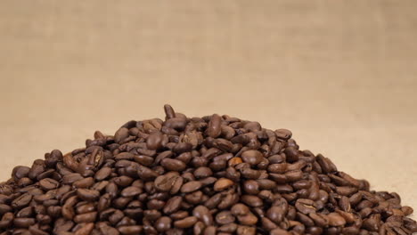 coffee beans arabica falling isolated on jute background