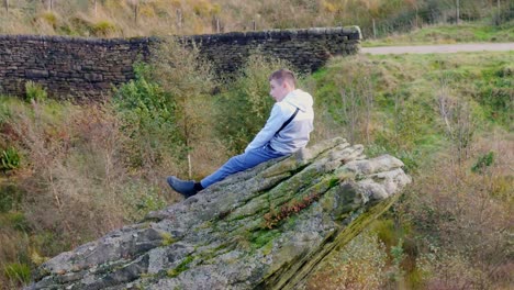 youth on massive stone, lost in contemplation