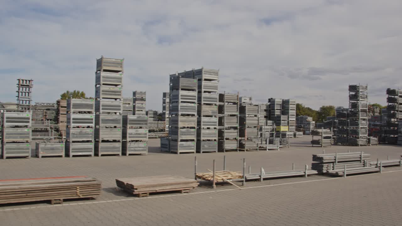 Wide pan of stacked materials on an industrial storage yard on a sunny day