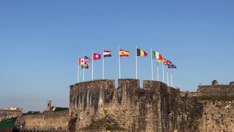 Static-view-of-flags-flying-over-the-fortified-town-Ville-Close-of-Concarneau-in-France