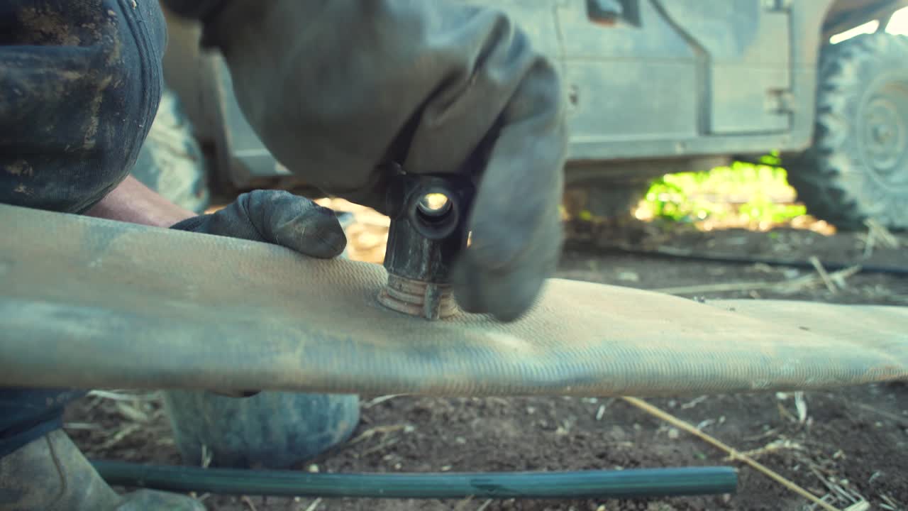 granjero instala un sistema de goteo en un campo de maíz