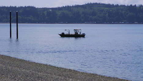 small, nondescript fishing floating near dock at camano island state park, wa state 10sec-60fps version 2