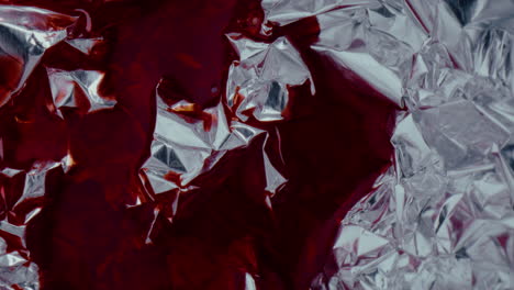 red liquid on crinkled silver foil