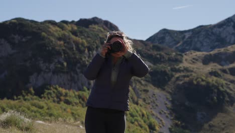 Frontal view of female nature photographer by Durmitor mountains in Montenegro