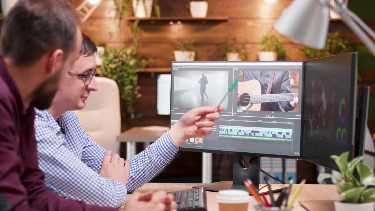 Video editing and post production with two men in the office