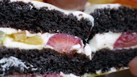 sliced chocolate cake with fruits and whipped cream