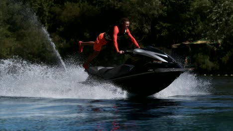 sportsman riding on speedy jet ski. extreme rider training stunt on jetski