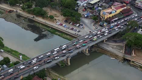 heavy traffic on marikina bridge spanning over marikina river in marikina city, philippines. aerial shot