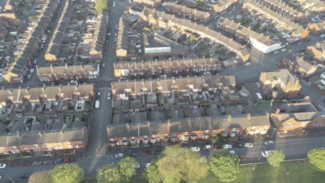 aerial view above typical british neighbourhood housing estate at sunrise rising birds eye shot