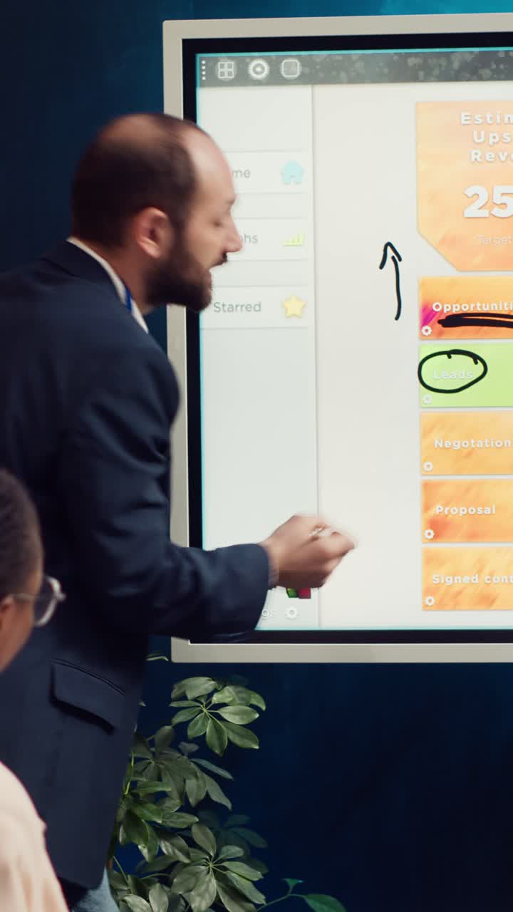 Businessman Presenting Sales Analytics on Interactive Digital Screen