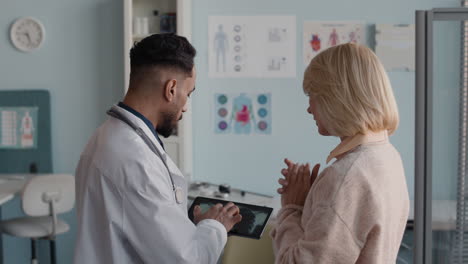 doctor explaining x-ray results to patient