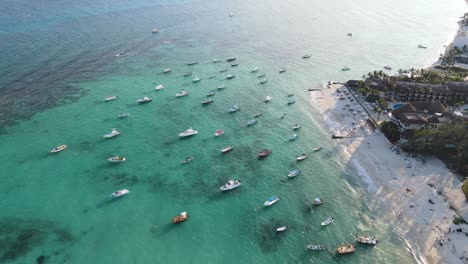 Luxury-yachts-and-boats-docked-anchored-on-a-tropical-island