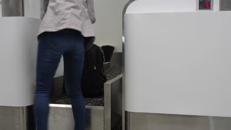 tourist girl checking the weight of her bag in check-in counter