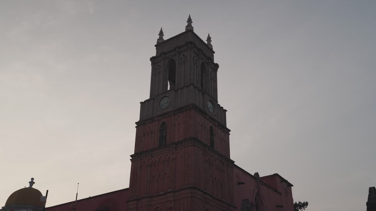 A church clock tower against a cloudy sky