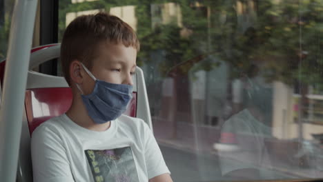 Nine-years-old-boy-with-a-face-mask-in-the-bus