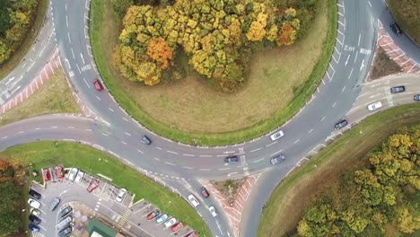 high angle view rising above roundabout traffic in grass urban junction top view