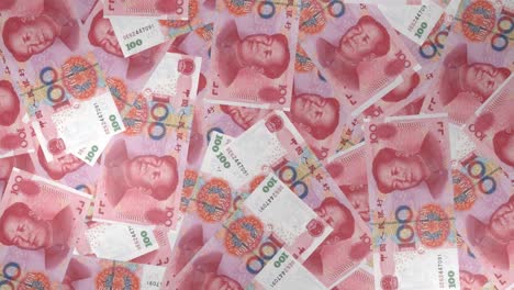 100 chinese yuan bills background. many banknotes.