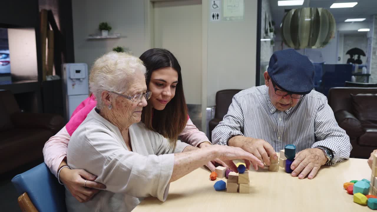 Elderly people interacting with a young adult