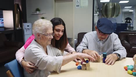 Elderly people interacting with a young adult