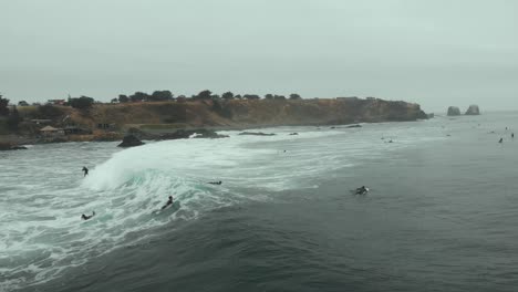 aerial following surfer riding wave of foam at high speed, pichilemu, chile-4k