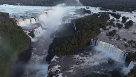 aerial flyover majestic iguazu falls border between brazil and argentina - splashing water of garganta del diablo in background