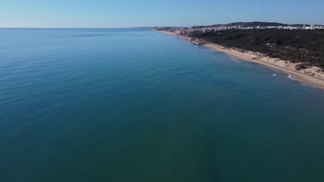 Flying-along-the-beach-of-Guardamar-del-Segura,-Spain