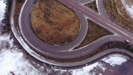 drone ascending above road in vansbro, sweden, a cloudy winter day