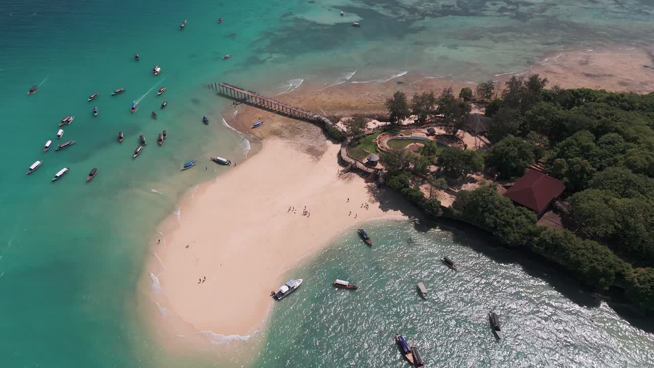 Changuu Island aerial view showcasing boats, clear water, sandy beaches, and lush greenery