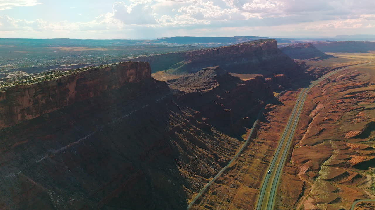 Spectacular view of huge rocks in the national park of Utah, USA. Roads passing through the canyons on sunny hot day. Aerial view.