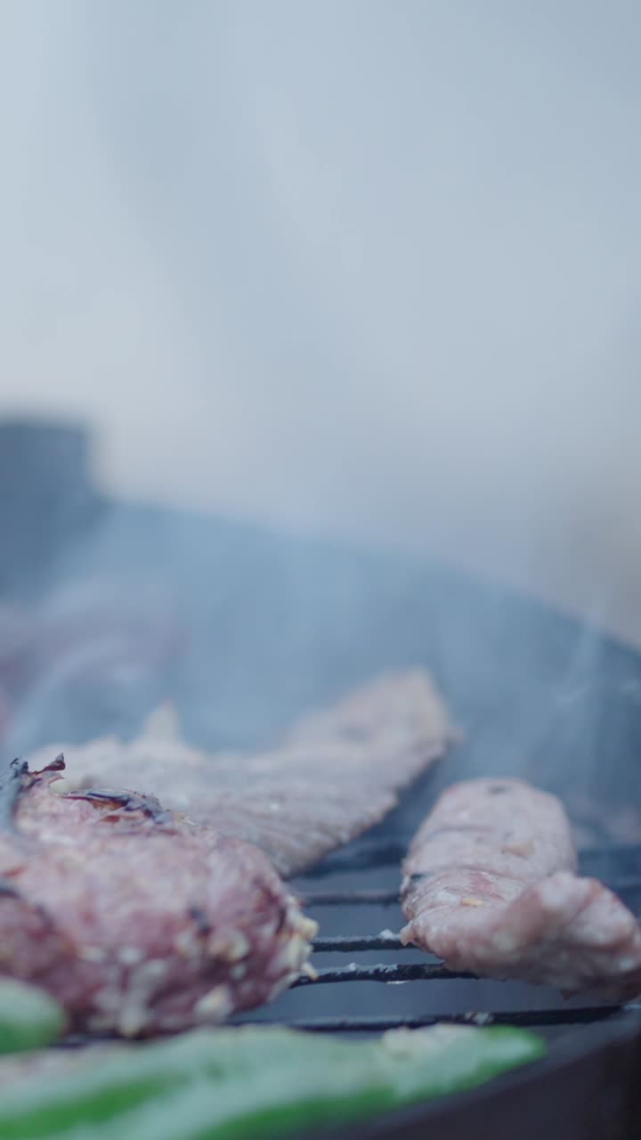 Grilling meat on a barbecue with a spatula