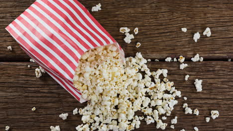 animation of box of popcorn over wooden table