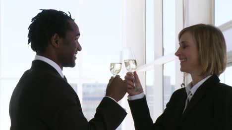 Two-business-people-toasting-their-success